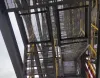 Welded Steel Grating installed at a construction site, viewed from below, demonstrating its use in industrial platforms and walkways
