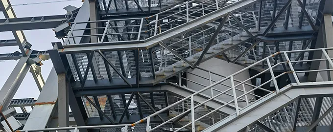 Welded Steel Grating applied on a factory staircase, providing safe and durable steps for workers in a construction environment
